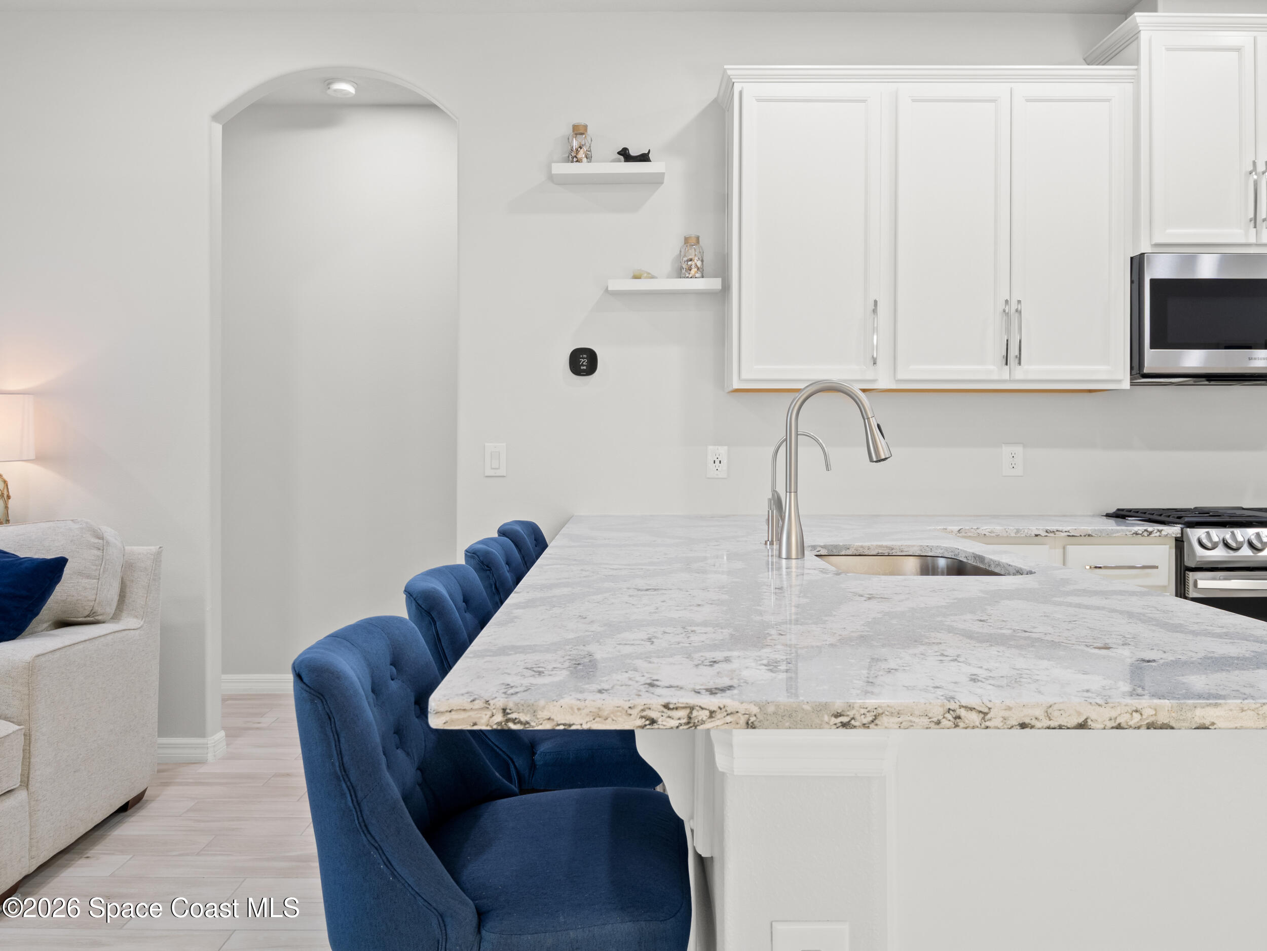 3363 Addison Drive Melbourne, FL 32940 - Photo 9 of 53 a kitchen with granite countertop a sink a stove and cabinets