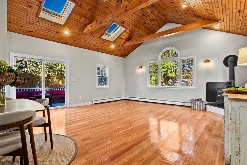 a view of a livingroom with furniture window and wooden floor