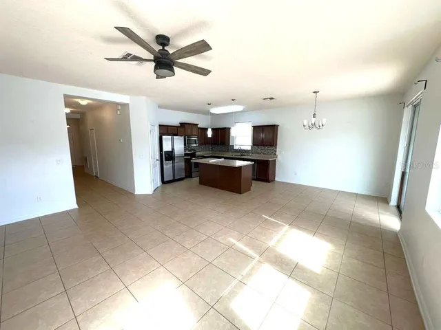 a living room with stainless steel appliances kitchen island granite countertop furniture and a kitchen view