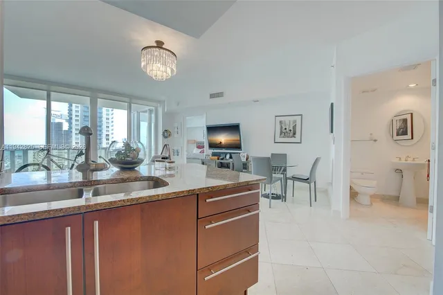 a view of living room with granite countertop furniture and a flat screen tv