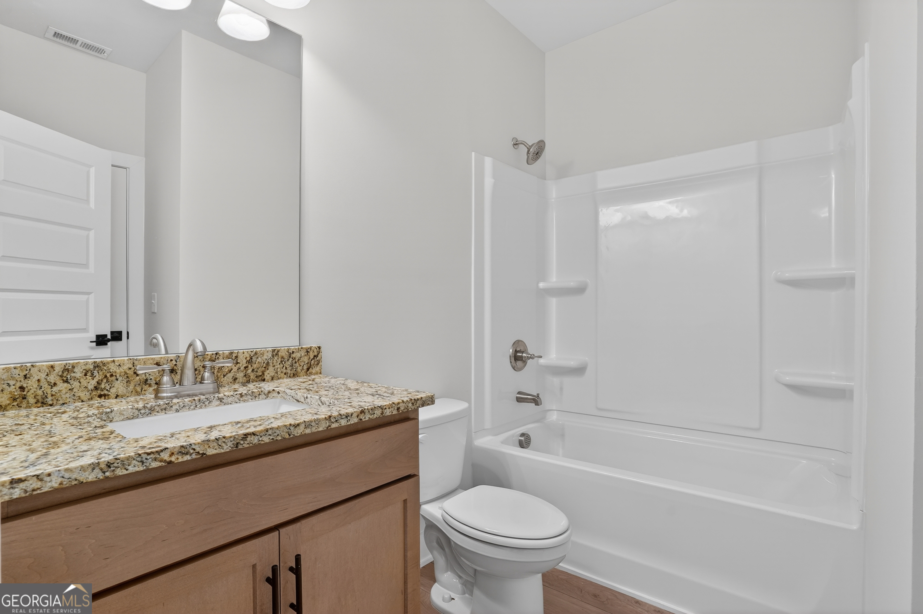 611 Villa Rica Springs Villa Rica, GA 30180 - Photo 17 of 35 a bathroom with a granite countertop sink a toilet and shower