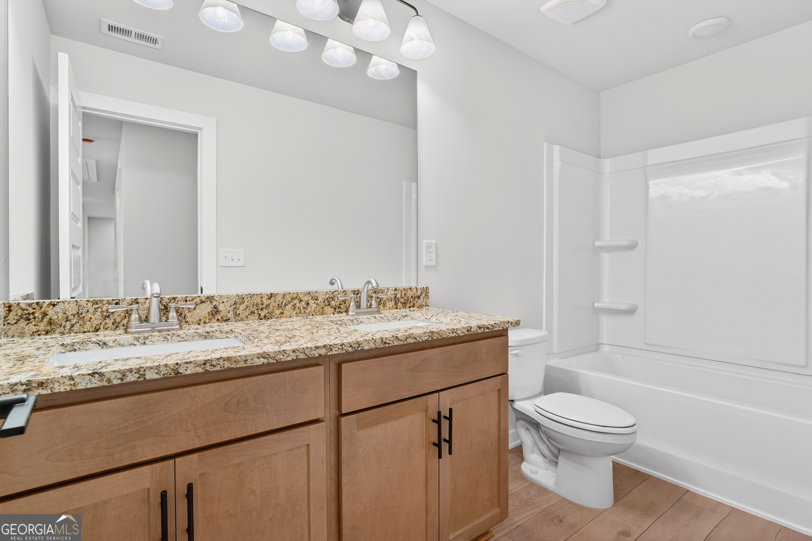 611 Villa Rica Springs Villa Rica, GA 30180 - Photo 31 of 35 a bathroom with a granite countertop sink toilet a mirror and shower