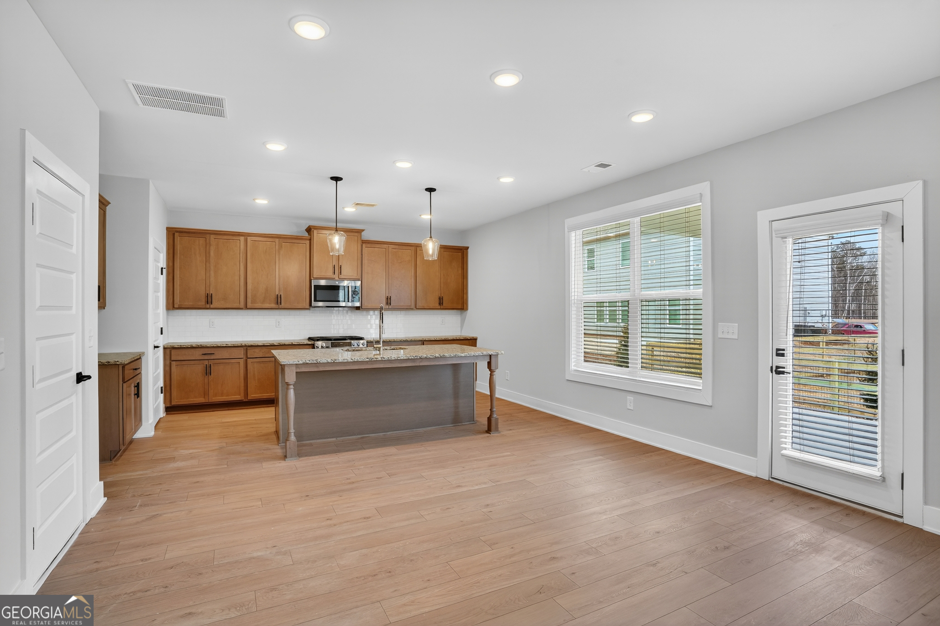 611 Villa Rica Springs Villa Rica, GA 30180 - Photo 5 of 35 a large kitchen with stainless steel appliances kitchen island granite countertop a large counter top and a stove top oven