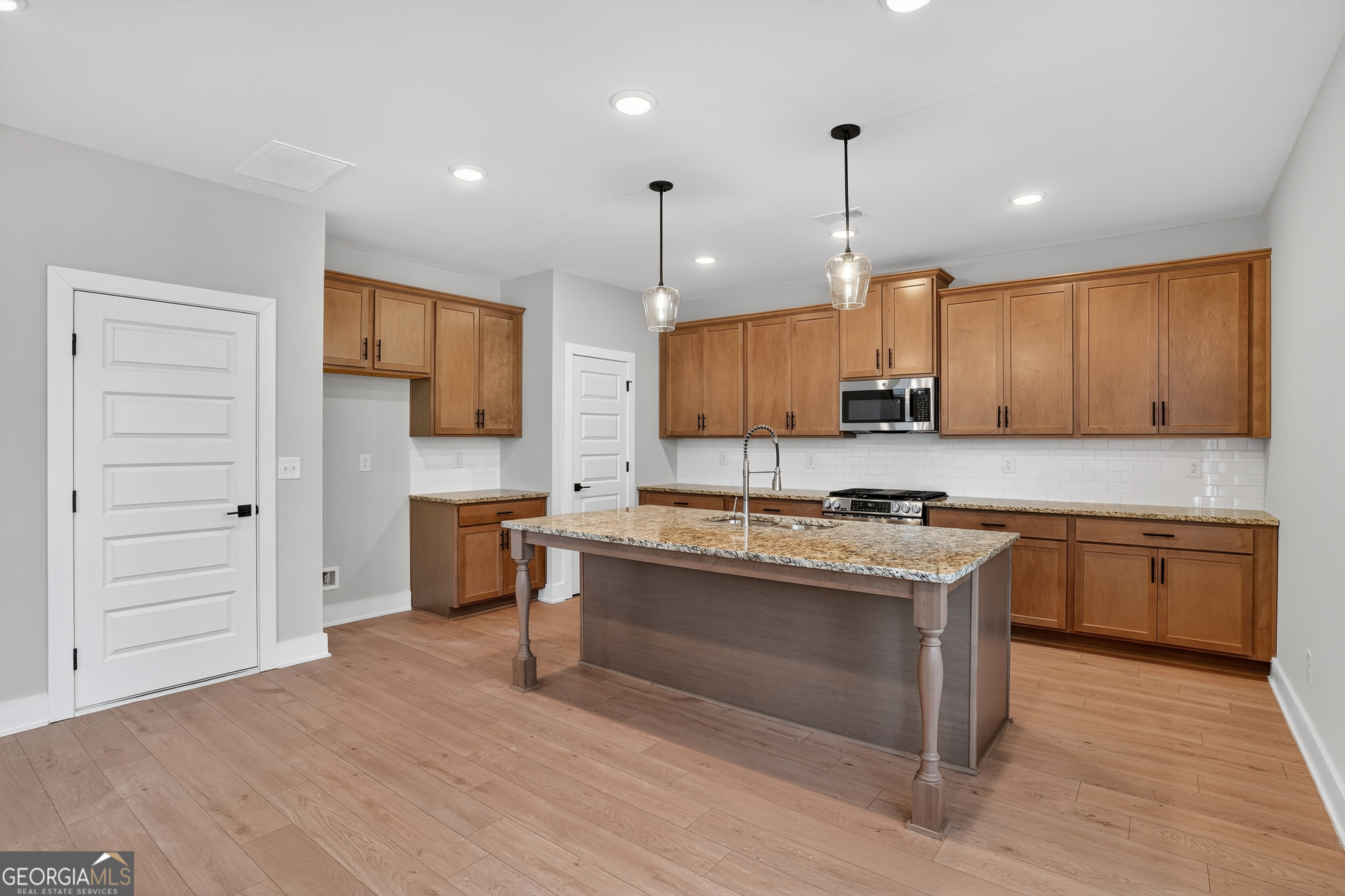 611 Villa Rica Springs Villa Rica, GA 30180 - Photo 7 of 35 a kitchen with kitchen island granite countertop wooden cabinets and a stove