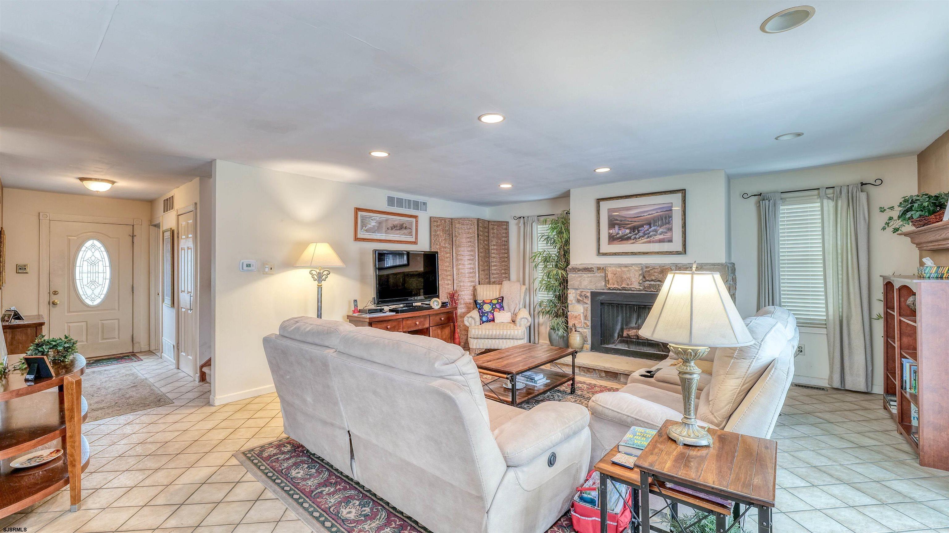 1330 Ouimet Road Brigantine, NJ 08203 - Photo 13 of 43 a living room with furniture a flat screen tv and a table