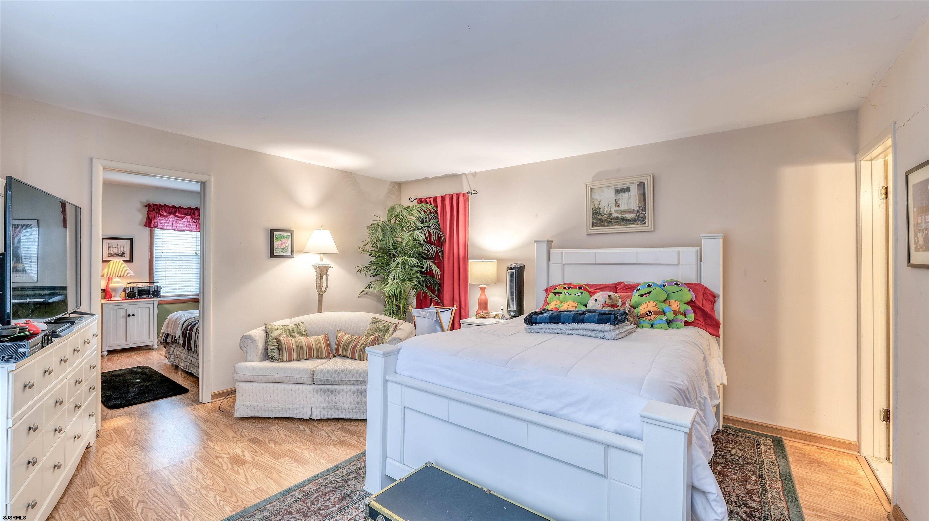 1330 Ouimet Road Brigantine, NJ 08203 - Photo 14 of 43 a bedroom with furniture and a flat screen tv