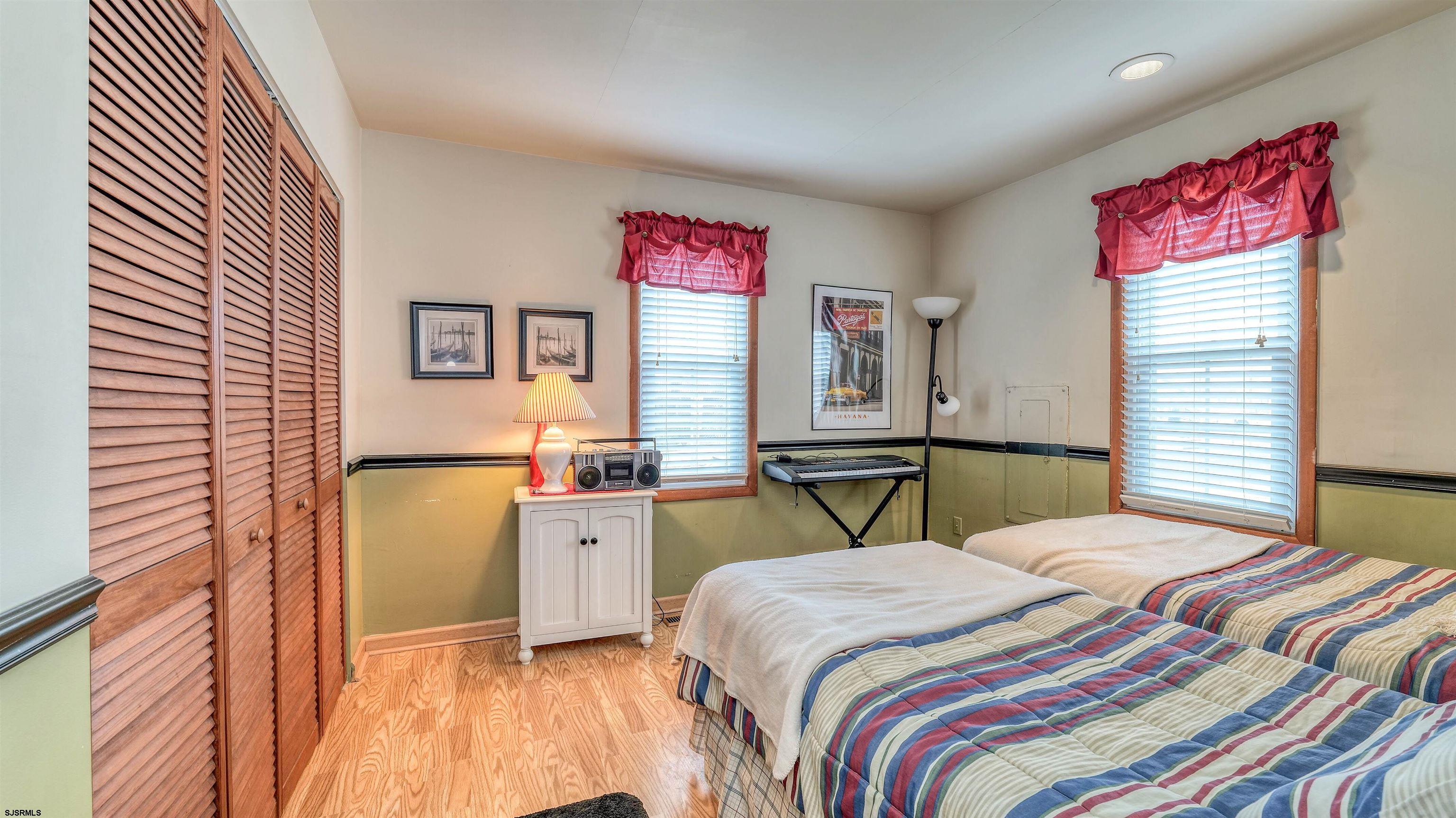 1330 Ouimet Road Brigantine, NJ 08203 - Photo 17 of 43 a bedroom with a bed and a dresser