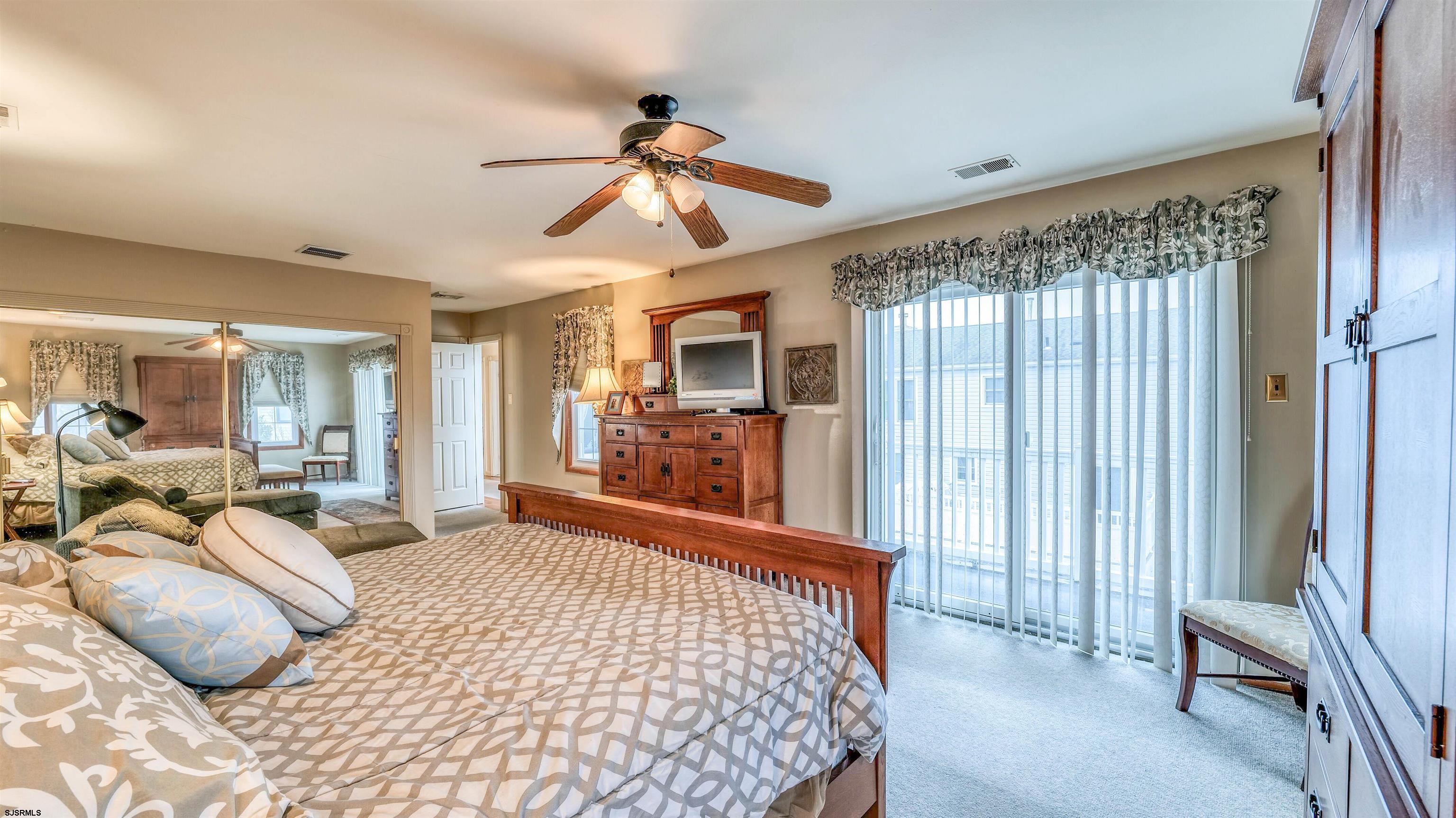 1330 Ouimet Road Brigantine, NJ 08203 - Photo 20 of 43 a bedroom with a bed and a chandelier