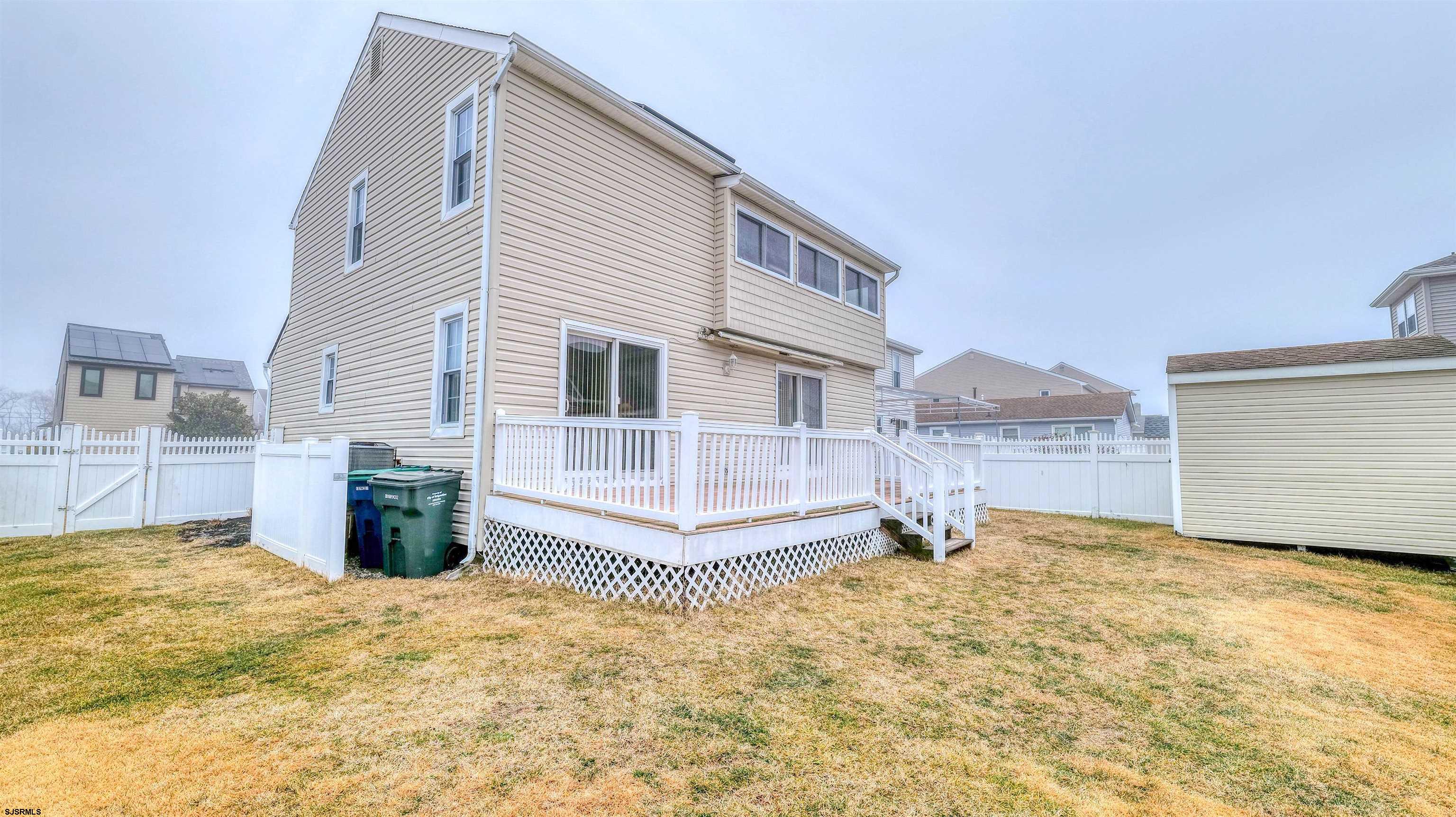 1330 Ouimet Road Brigantine, NJ 08203 - Photo 28 of 43 a view of a house with backyard and glass windows