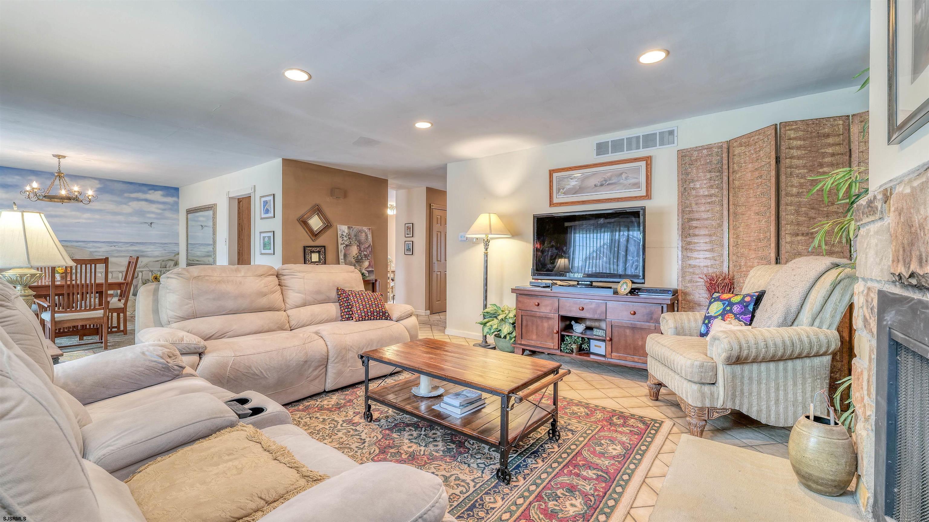 1330 Ouimet Road Brigantine, NJ 08203 - Photo 6 of 43 a living room with furniture a large window and a fireplace