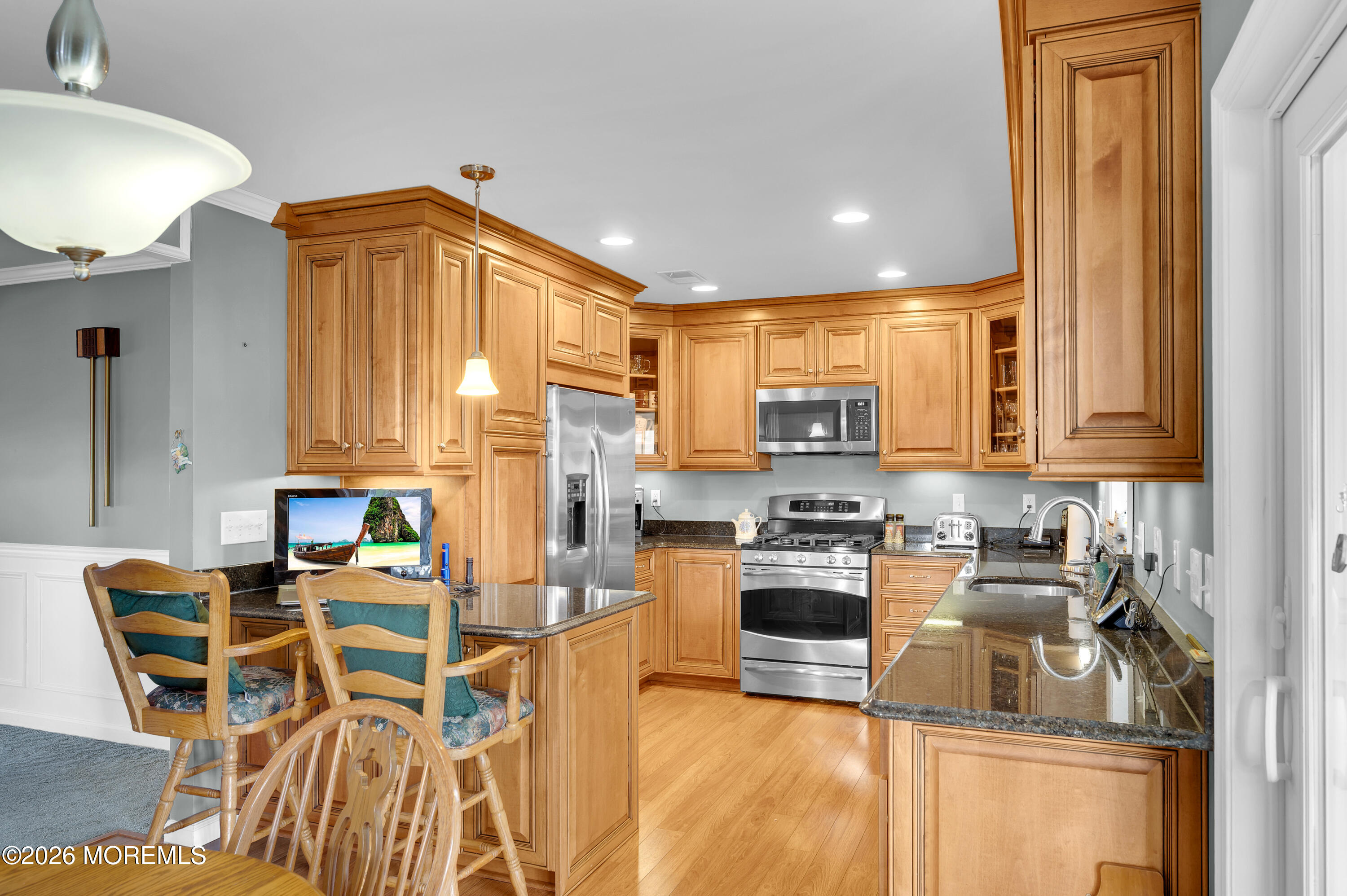 1005 Plimsoll Point Lanoka Harbor, NJ 08734 - Photo 26 of 54 a kitchen with stainless steel appliances granite countertop a stove top oven a sink a dining table and chairs