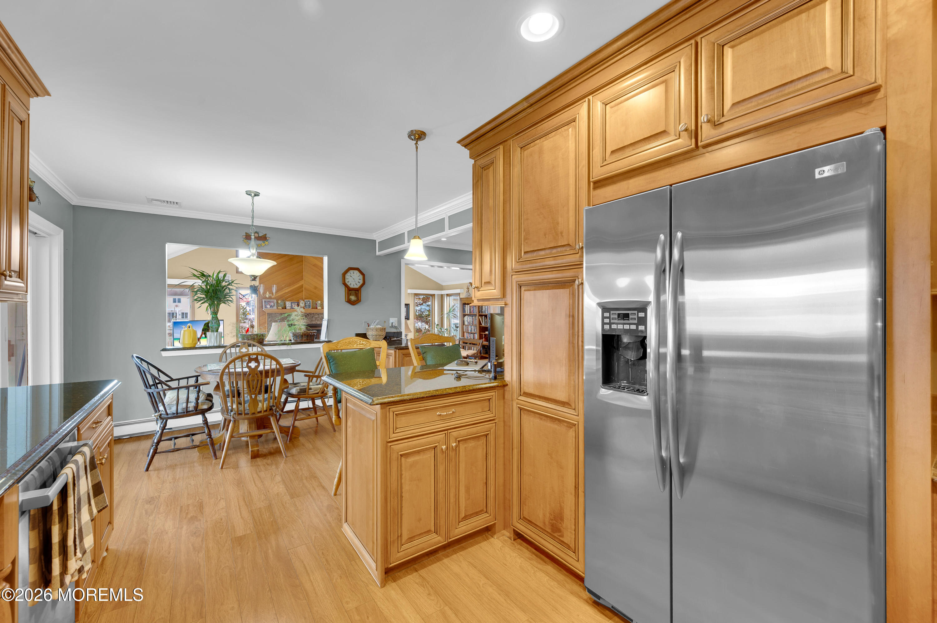 1005 Plimsoll Point Lanoka Harbor, NJ 08734 - Photo 32 of 54 a kitchen with stainless steel appliances granite countertop a refrigerator a stove a dining table and chairs with wooden floor