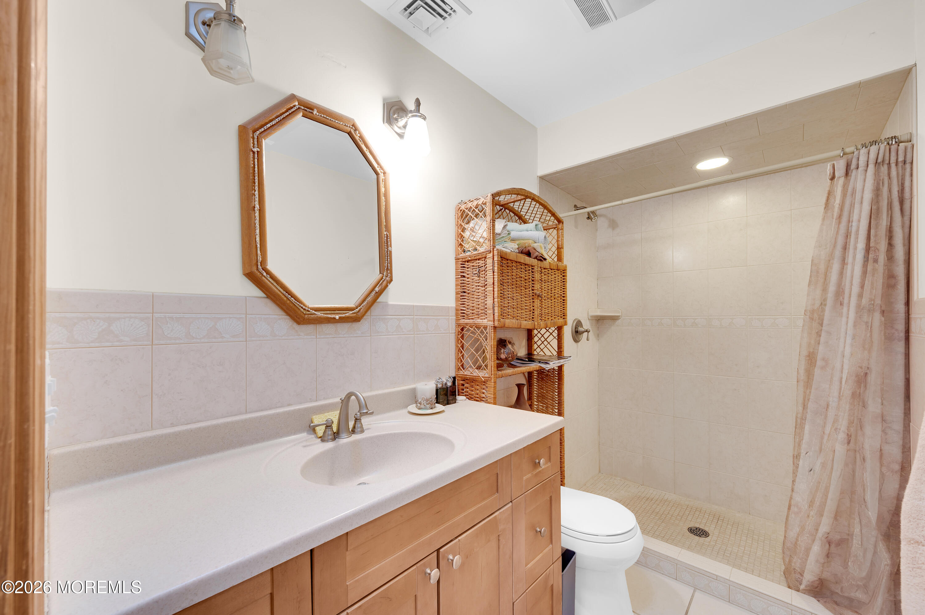 1005 Plimsoll Point Lanoka Harbor, NJ 08734 - Photo 8 of 54 a bathroom with a sink a toilet and a mirror