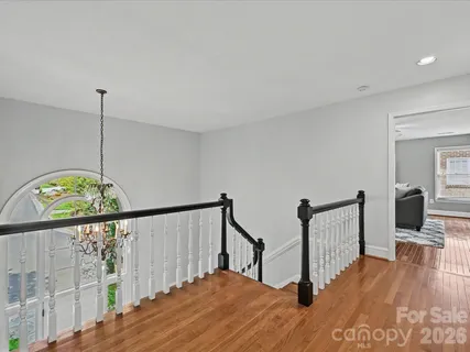 a view of hallway with wooden floor