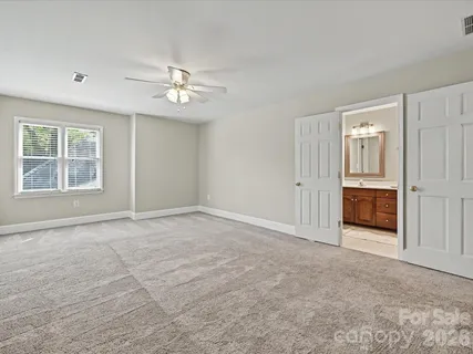 an empty room with windows and closet