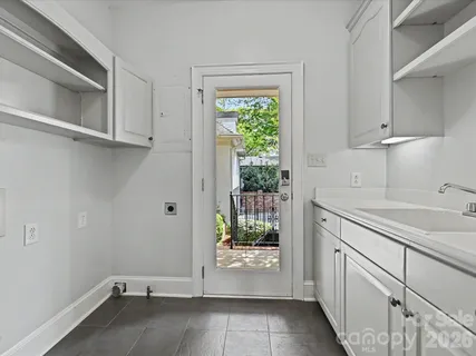 a view of a kitchen with white cabinets and a sink
