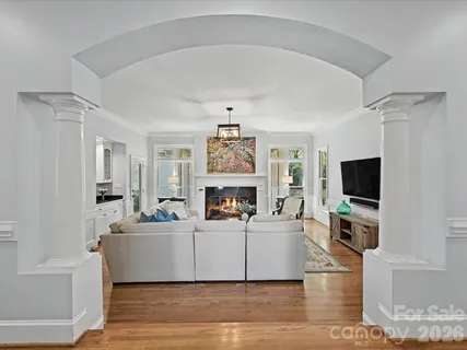 a living room with fireplace furniture and a flat screen tv