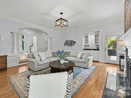 a living room with furniture a rug and a chandelier