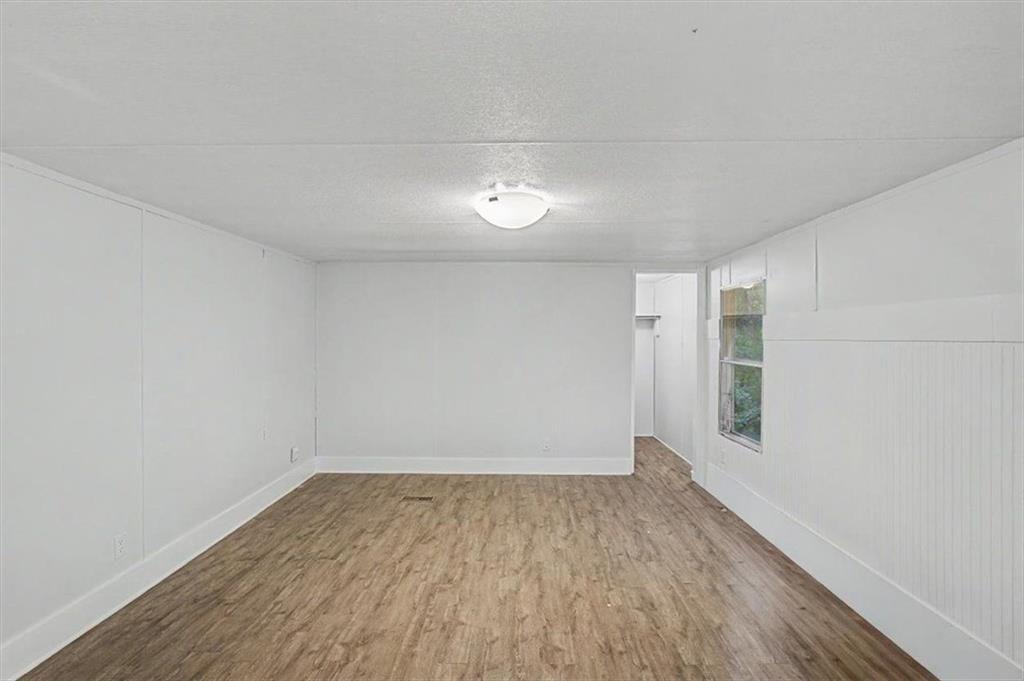 360 Black Knob Church Road Ranger, GA 30734 - Photo 14 of 20 a view of a room with wooden floor and white walls