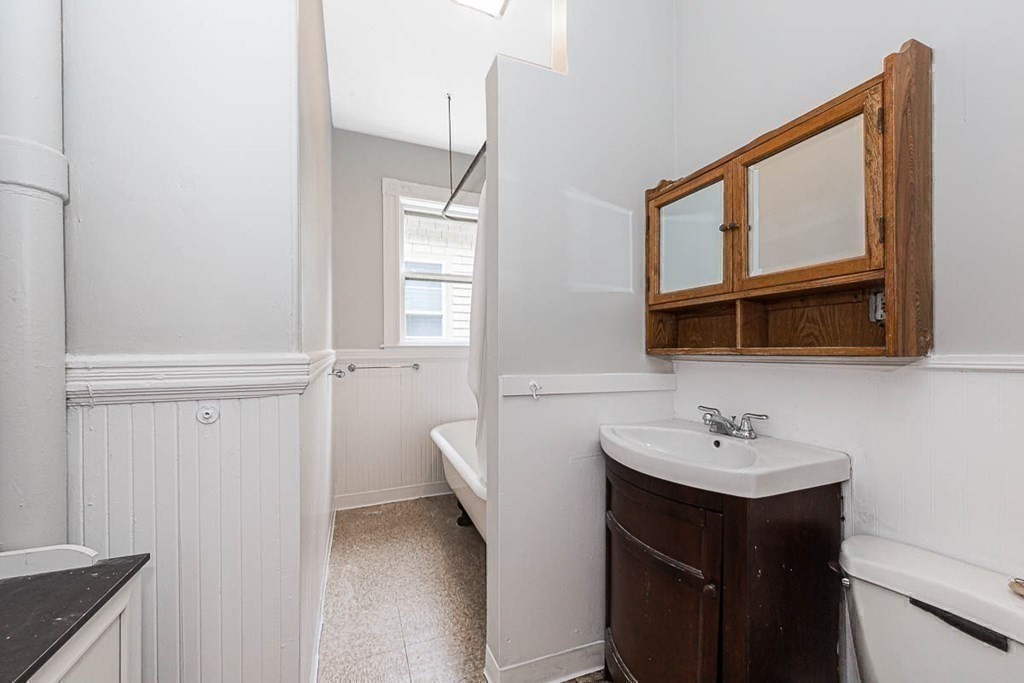 33 Stanton Road, Unit 2 Brookline, MA 02445 - Photo 14 of 19 a bathroom with a sink a mirror and a toilet