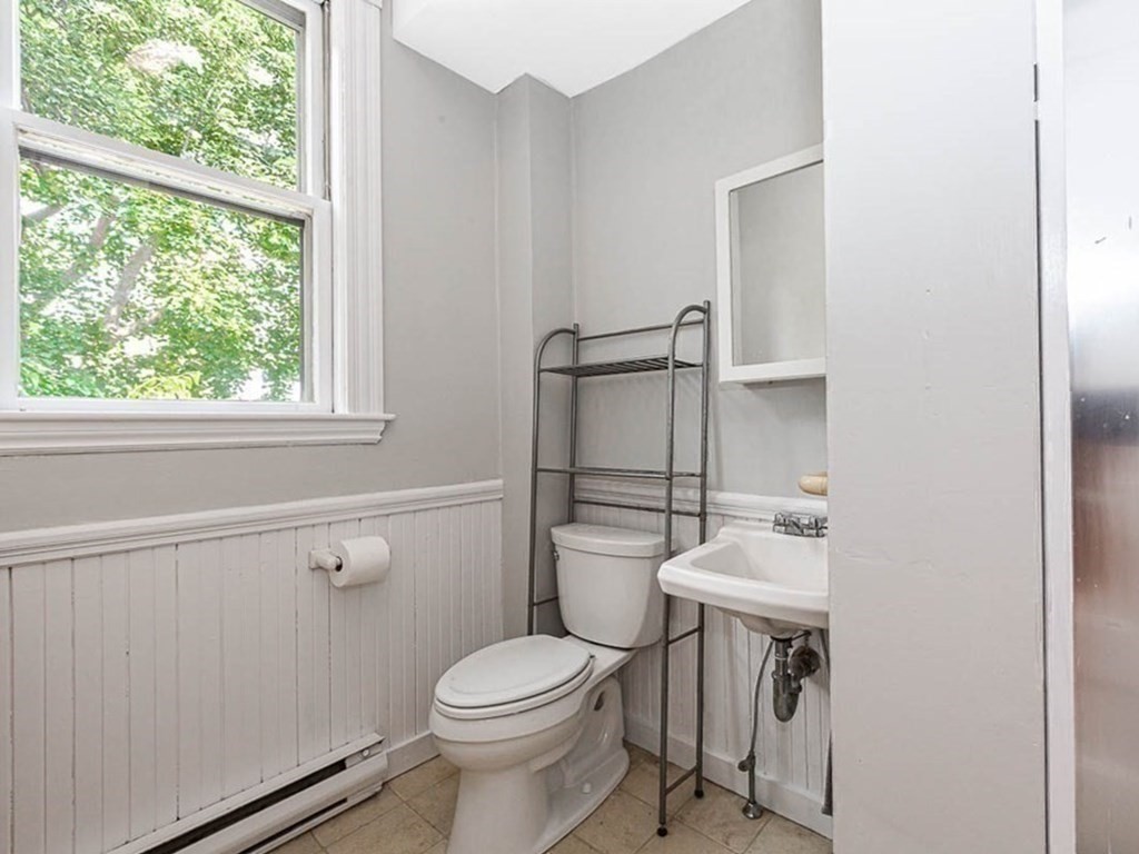 33 Stanton Road, Unit 2 Brookline, MA 02445 - Photo 16 of 19 a white toilet sitting next to a bathroom sink