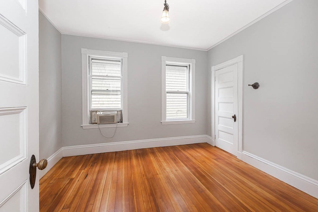 33 Stanton Road, Unit 2 Brookline, MA 02445 - Photo 17 of 19 an empty room with wooden floor and windows