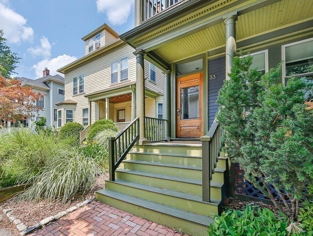 33 Stanton Road, Unit 2 Brookline, MA 02445 - Photo 2 of 19 a view of a house with a small yard and wooden floor and fence