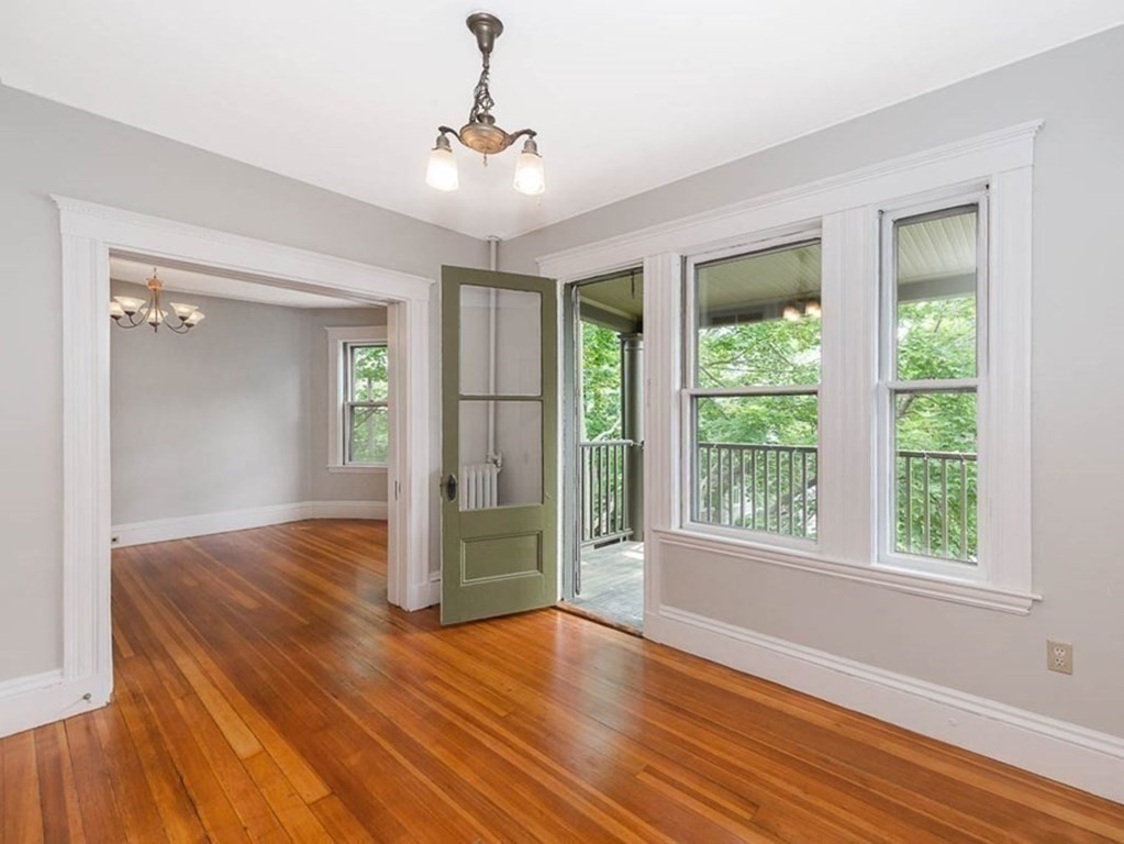 33 Stanton Road, Unit 2 Brookline, MA 02445 - Photo 4 of 19 a view of wooden floor and windows in a room
