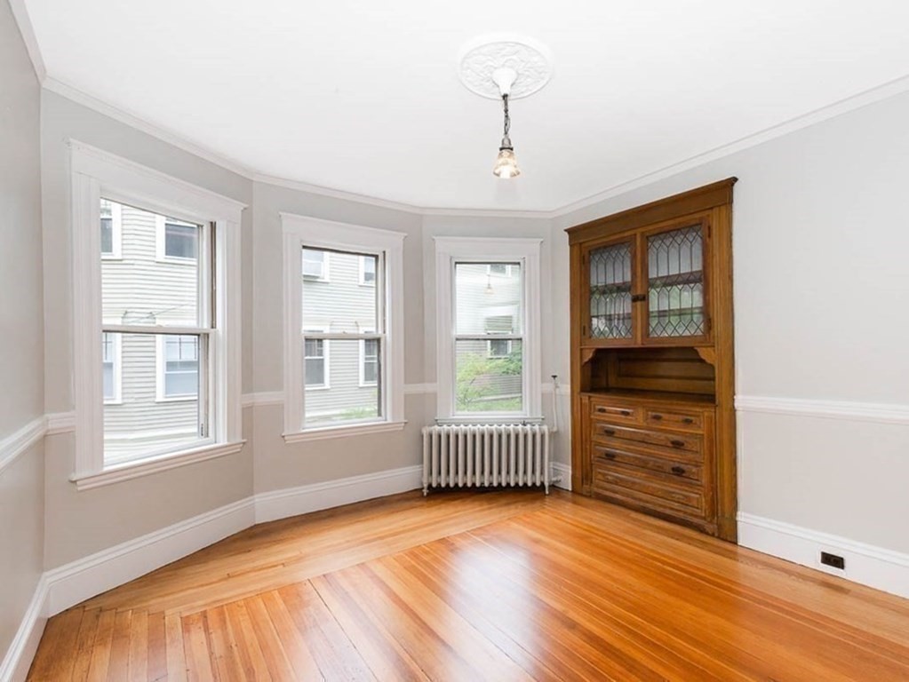 33 Stanton Road, Unit 2 Brookline, MA 02445 - Photo 8 of 19 an empty room with cabinet and windows