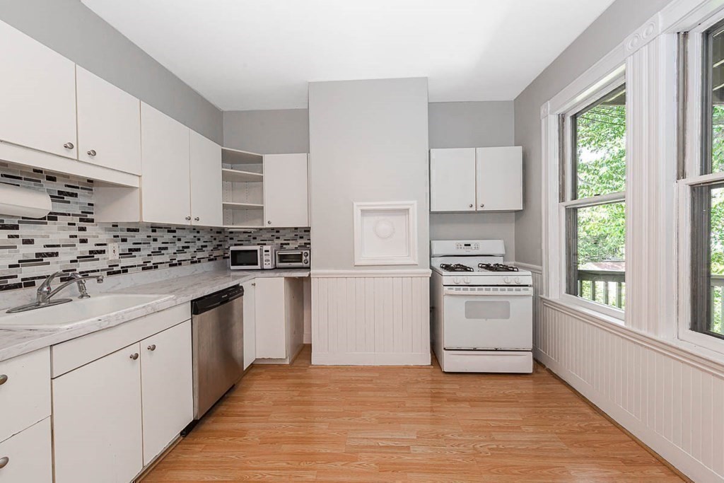 33 Stanton Road, Unit 2 Brookline, MA 02445 - Photo 9 of 19 a kitchen with granite countertop a stove a sink and a refrigerator
