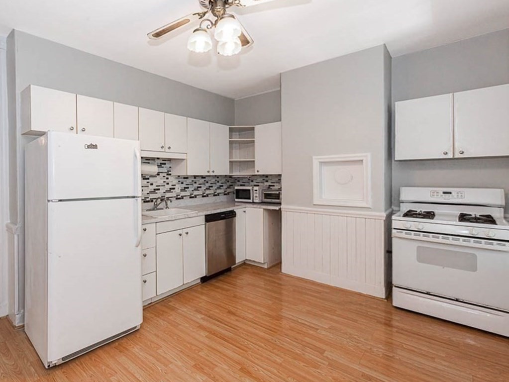 33 Stanton Road, Unit 2 Brookline, MA 02445 - Photo 10 of 19 a kitchen with white cabinets and white appliances