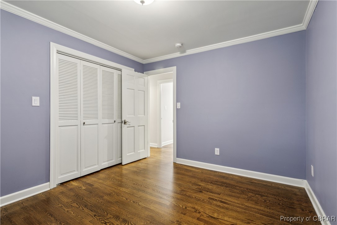 9300 Marlfield Road Gloucester, VA 23061 - Photo 29 of 50 Unfurnished bedroom featuring ornamental molding, hardwood / wood-style floors, and a closet