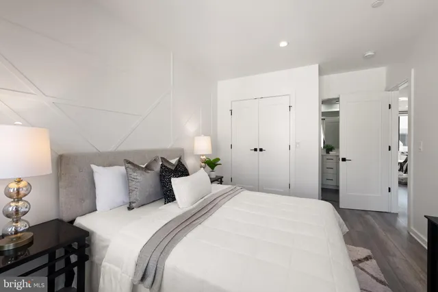 a bedroom with a bed and a potted plant