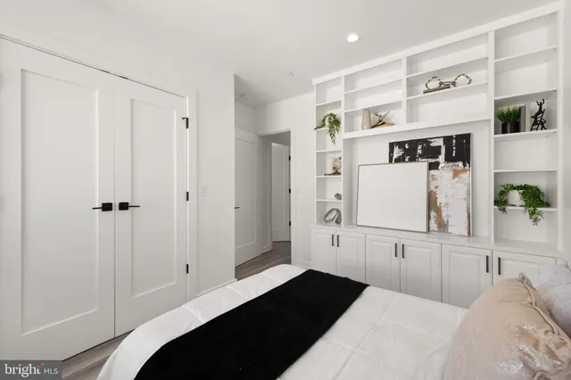 a bedroom with a bed and painting on the wall