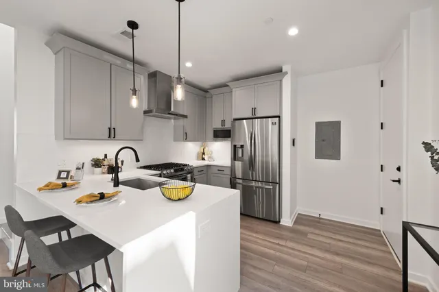 a kitchen with stainless steel appliances granite countertop a stove a refrigerator and a sink