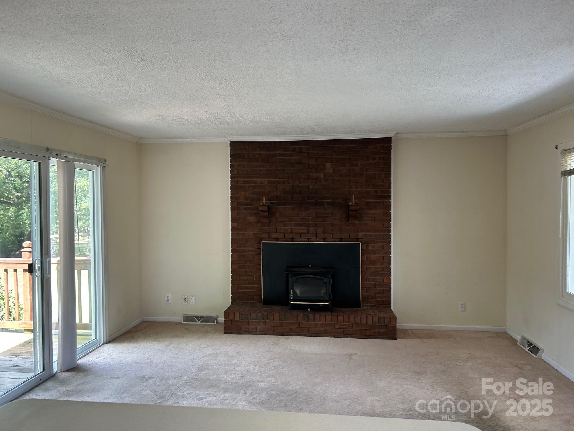 9025 Sorrow Farm Road Kannapolis, NC 28081 - Photo 7 of 21 an empty room with a fireplace