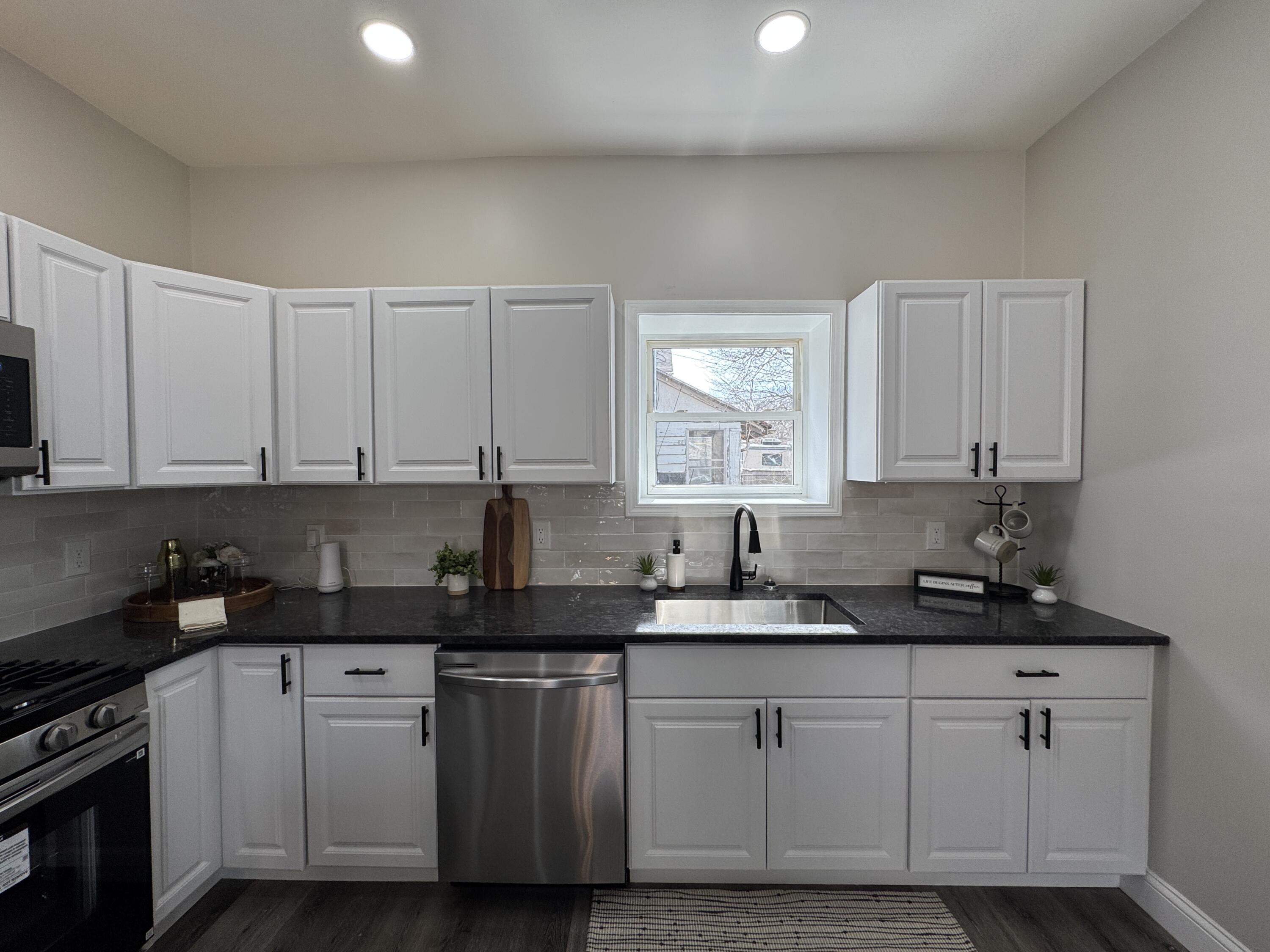 800 Buchanan Street Gary, IN 46402 - Photo 12 of 29 a kitchen with granite countertop white cabinets and a sink