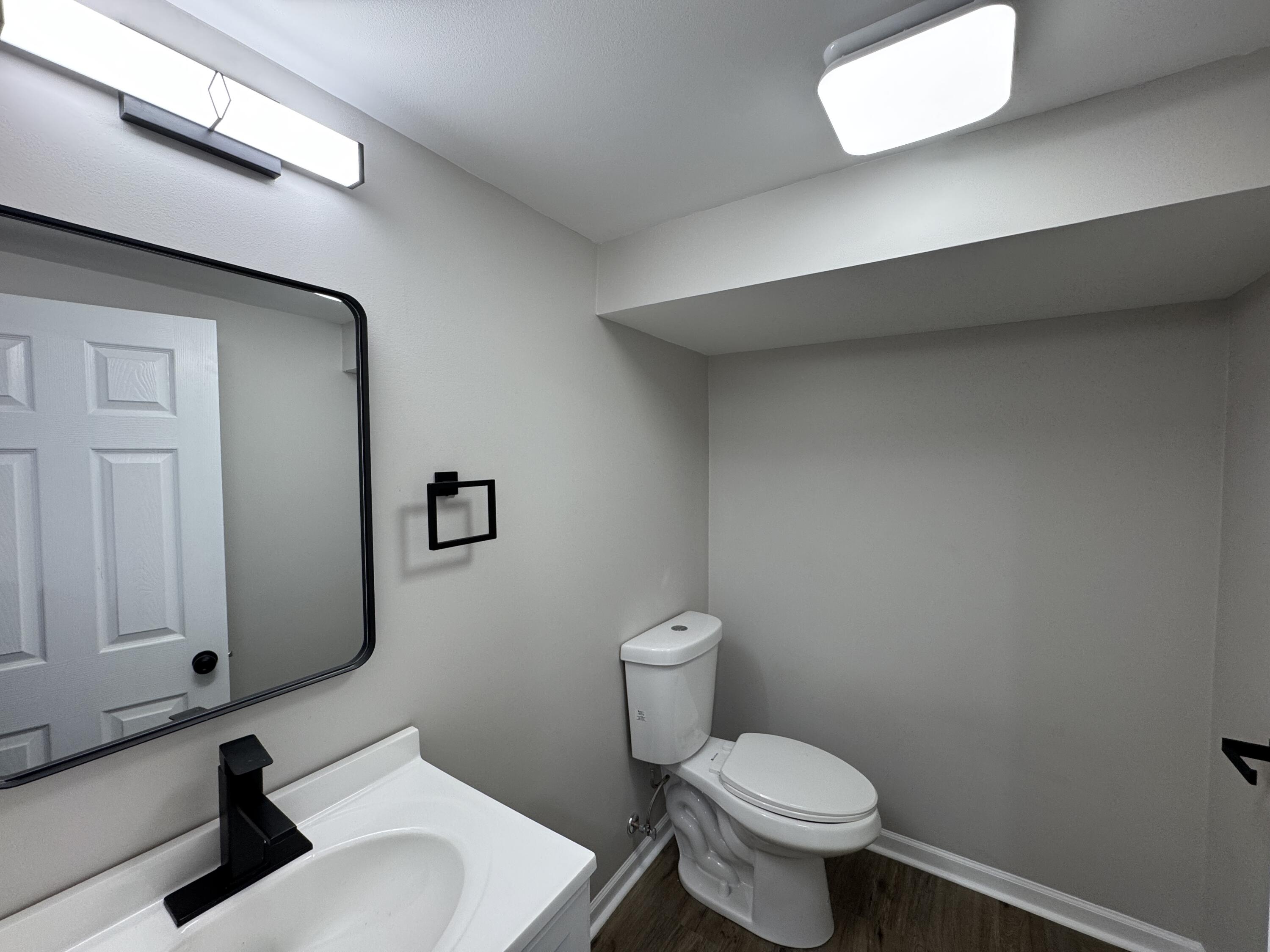800 Buchanan Street Gary, IN 46402 - Photo 28 of 29 a bathroom with a toilet sink and mirror
