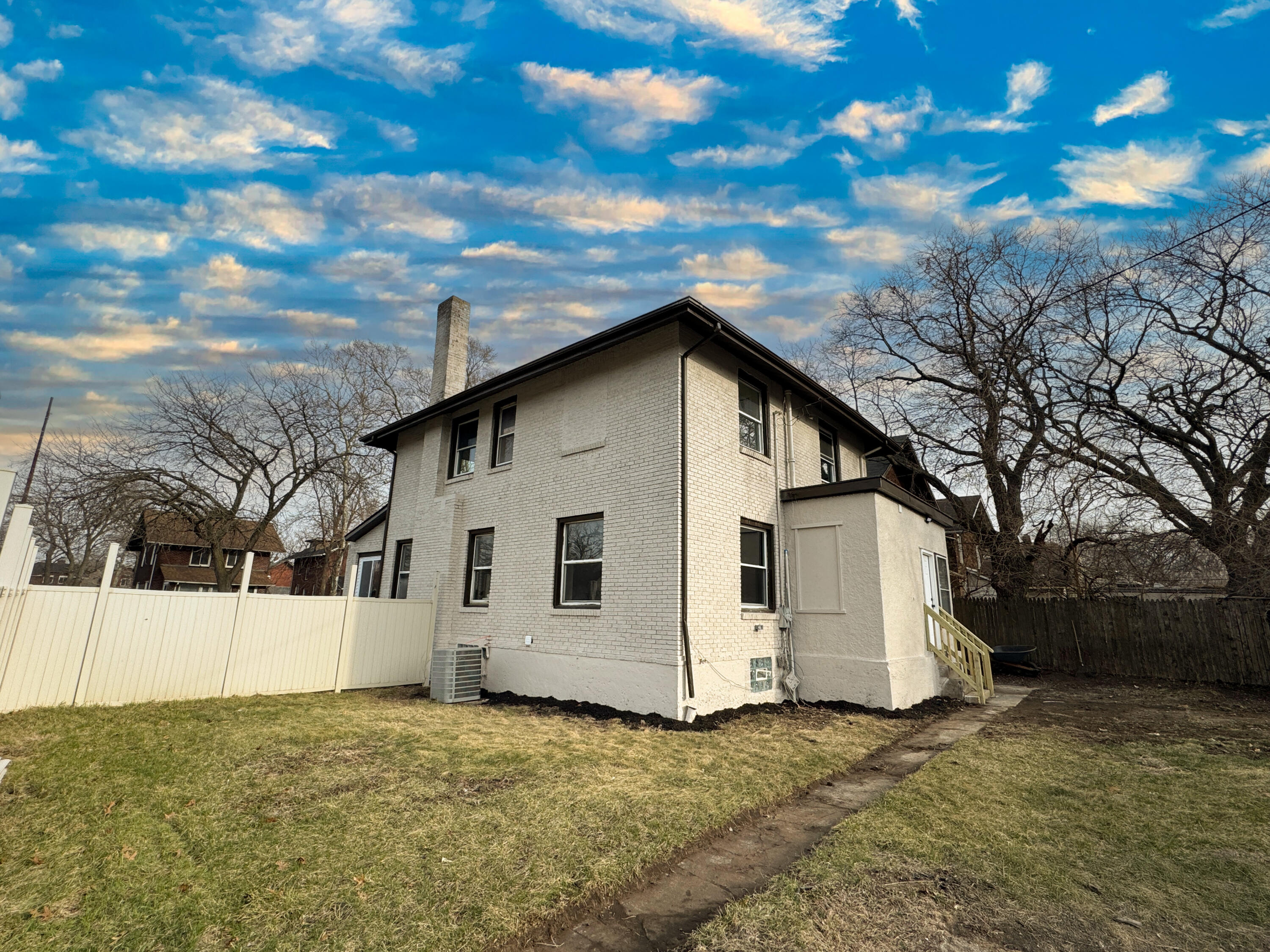 800 Buchanan Street Gary, IN 46402 - Photo 29 of 29 a view of a white house with a large tree