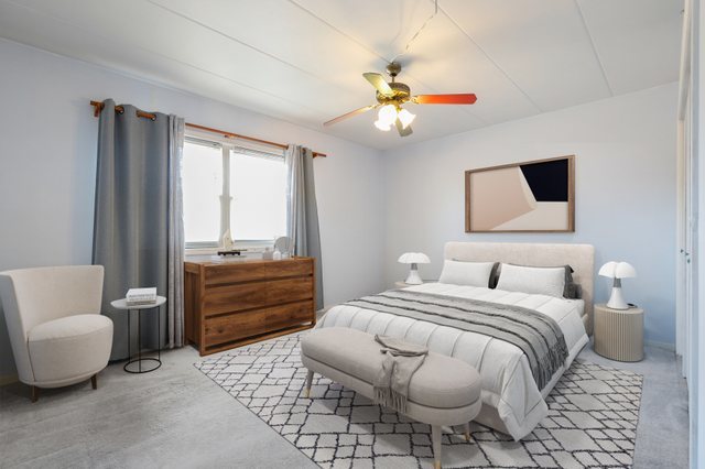 3704 215th Street, Unit 205 Matteson, IL 60443 - Photo 12 of 16 a bedroom with a bed and a chandelier