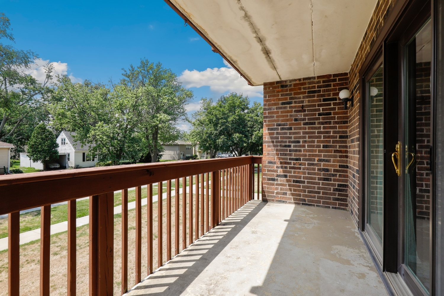 3704 215th Street, Unit 205 Matteson, IL 60443 - Photo 14 of 16 a view of a balcony with wooden floor