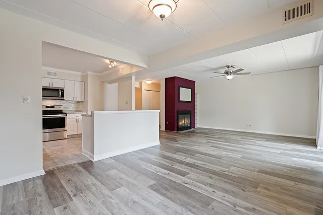 a view of a kitchen with furniture and wooden floor