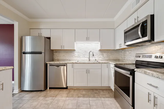 a kitchen with a refrigerator stove and microwave