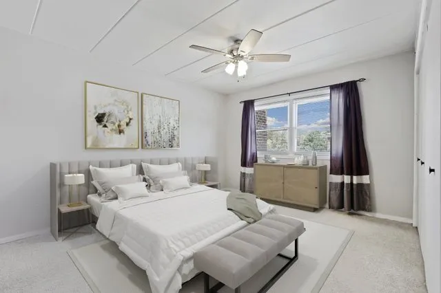 a bedroom with a large bed and a window