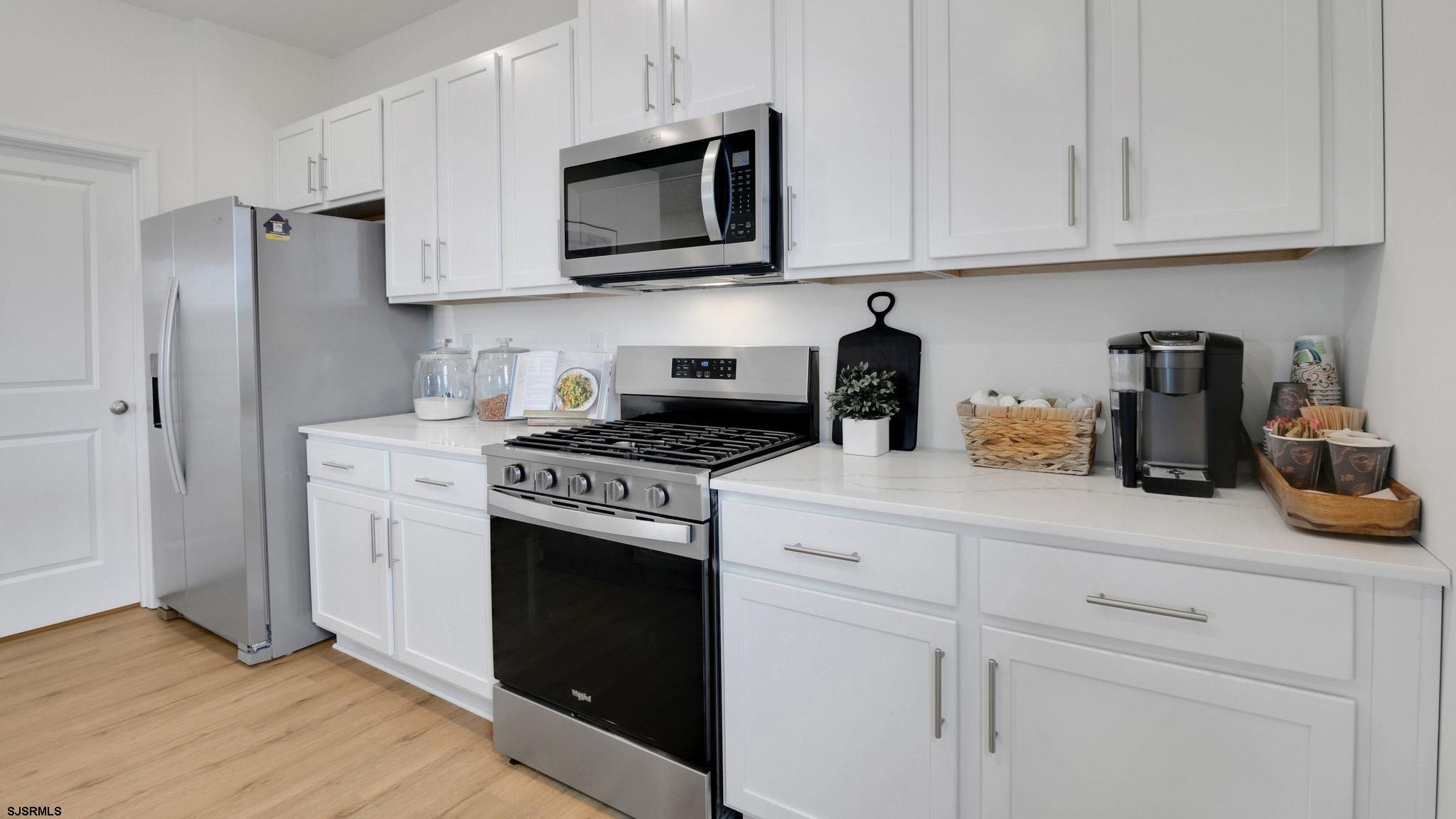 224 Daytona Road Egg Harbor Township, NJ 08234 - Photo 16 of 31 a kitchen with stainless steel appliances granite countertop white cabinets sink and a granite counter tops