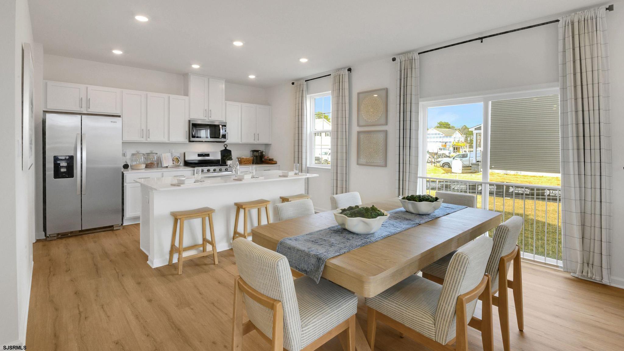 224 Daytona Road Egg Harbor Township, NJ 08234 - Photo 24 of 31 a kitchen with a dining table chairs refrigerator and microwave