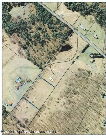 a view of multiple house with a small yard and deck