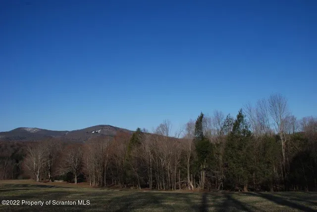 a view of a town with mountains in the background