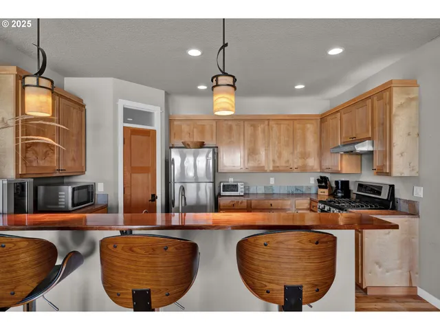 a kitchen with refrigerator cabinets and a sink