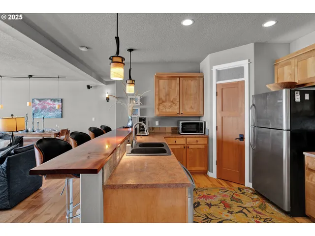 a kitchen with stainless steel appliances a stove a sink and a microwave